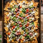 9 Delicious cheesy nachos topped with jalapeños, tomatoes, and onions, perfect for outdoor parties on.