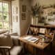 A charming farmhouse-style writing nook with a wooden desk, open books, and natural light from large.