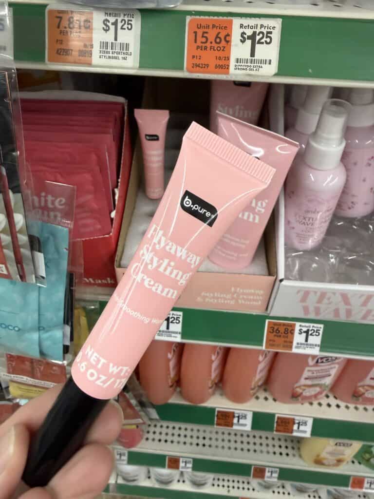 15 Dollar Tree Personal Care Finds I Actually Keep Buying (All Just $1.25!) 10 Pink skincare tube displayed on store shelf with other beauty products.