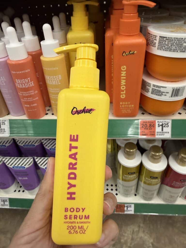 15 Dollar Tree Personal Care Finds I Actually Keep Buying (All Just $1.25!) 3 Bright yellow body serum bottle with pump dispenser on store shelf.