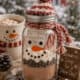 Festive hot cocoa mix jar with snowman decoration and winter background.