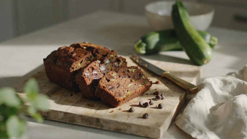 Chocolate Zucchini Bread (And 5 More Loaves From the Same Batter) 1 Close-up of a slice of chocolate zucchini bread on a wooden board.