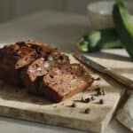 7 Close-up of a slice of chocolate zucchini bread on a wooden board.