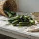 Freshly picked zucchinis on a rustic kitchen counter for zucchini recipes.