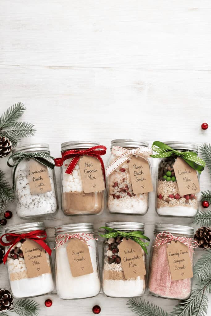 25 Mason Jar Christmas Gifts That Look Expensive (But Aren't) 2 Decorative mason jars with holiday-themed contents for Christmas gifts.