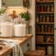 Organized kitchen pantry with jars, baskets, and shelves for storage.