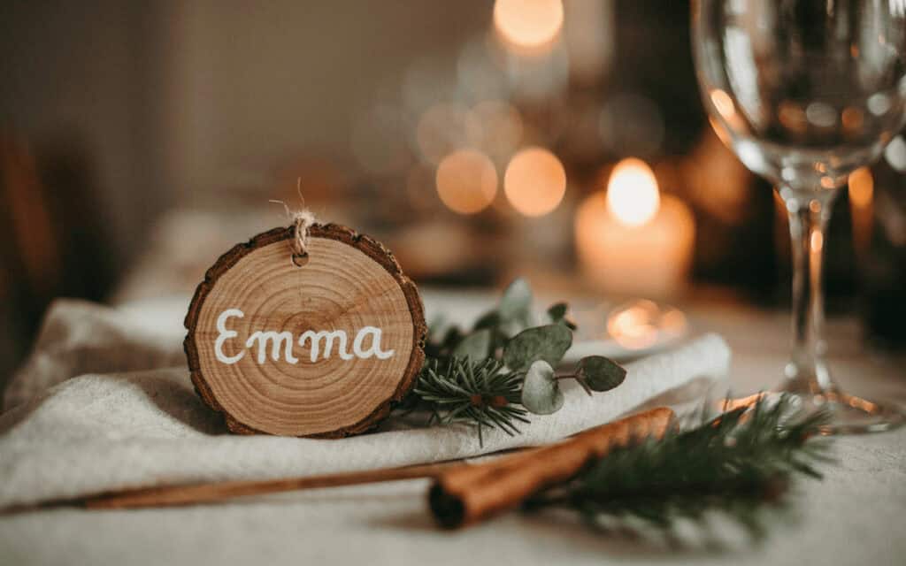 DIY Wood Slice Christmas Place Cards 3 Wood slice name tag with 'Emma' for Christmas table setting.