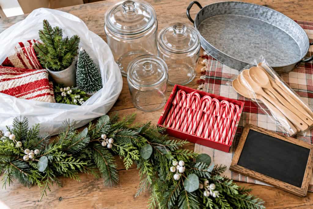 Hot Cocoa Bar Ideas: How to Set Up a Cozy Christmas Cocoa Station on a Budget. 4 Festive hot cocoa bar with jars, spoons, and holiday decorations.